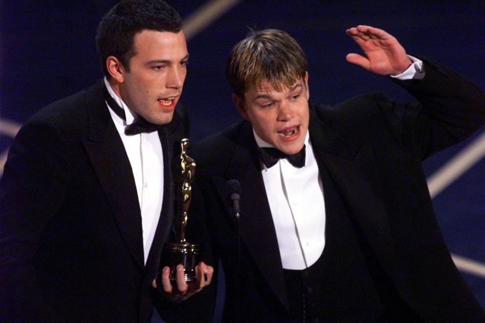 Ben Affleck, left, and Matt Damon accept the original screenplay Oscar for "Good Will Hunting" at the 70th Academy Awards in 1998. The friends have reunited as a writing pair for the new drama "The Last Duel."