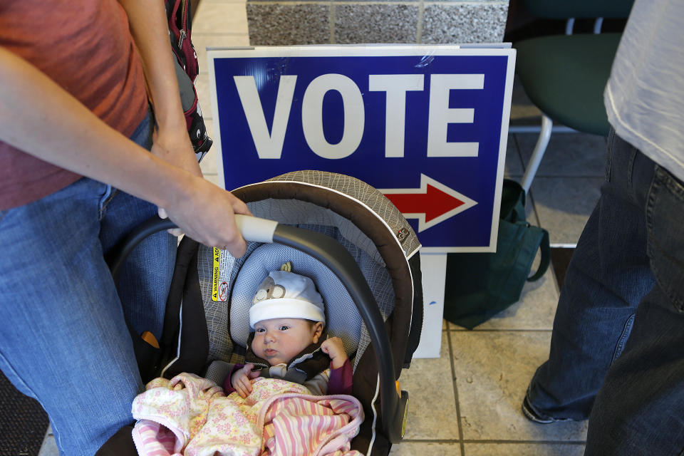 Lucille Sylvester of Boulder, Colorado holds her six-week-old daughter Cora Brehler as they wait in line to vote at the Boulder County Clerk and Recorder's Office on November 6, 2012 in Boulder, Colorado. Colorado is considered by most experts to be a key battleground state in this year's election. (Photo by Marc Piscotty/Getty Images)