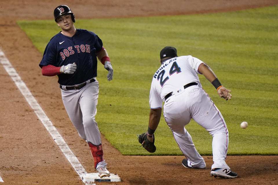 Boston Red Sox's Bobby Dalbec beats the throw to Miami Marlins first baseman Jesus Aguilar (24) for a singe during the fifth inning of a baseball game, Tuesday, Sept. 15, 2020, in Miami. (AP Photo/Lynne Sladky)