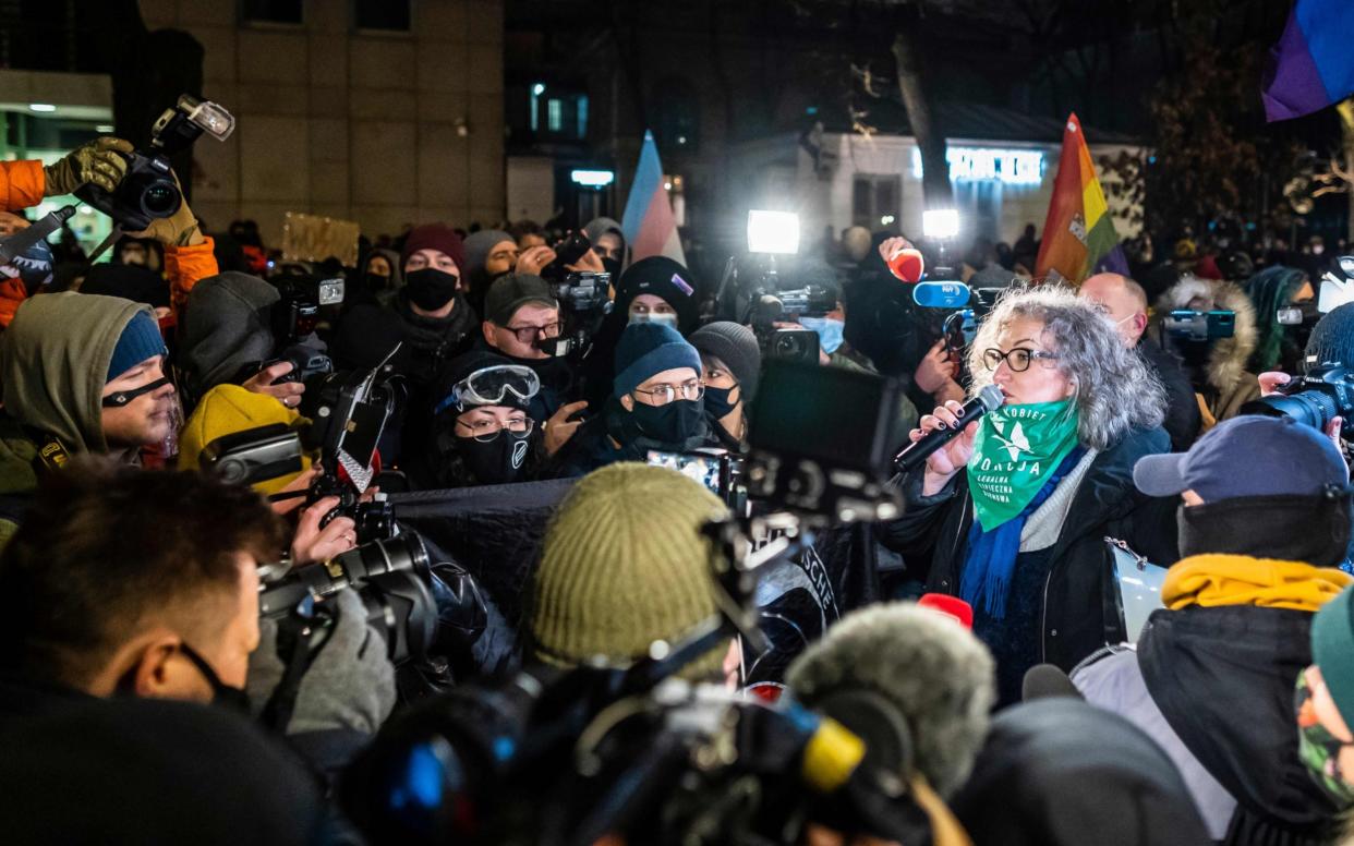 Marta Lempart (R), one of the Women's Strike movement leaders, as she speaks on the microphone during a pro-choice protest against Poland's near-total ban on abortion - WOJTEK RADWANSKI/AFP