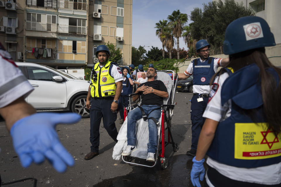 Paramedics evacuate wounded Israelis from a building struck by a rocket fired from Gaza, in Tel Aviv, Israel, Friday, Oct. 27, 2023. (AP Photo/Oded Balilty)