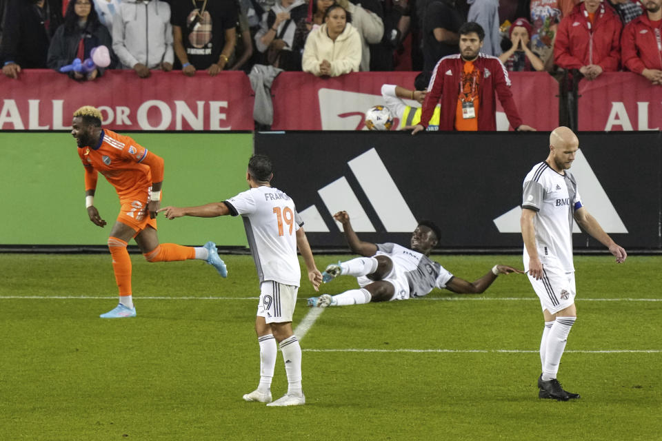 Toronto FC's Kobe Franklin (19), Aime Mabika and Michael Bradley, right, react as FC Cincinnati's Aaron Boupendza celebrates scoring during the second half of an MLS soccer match Saturday, Sept. 30, 2023, in Toronto. (Chris Young/The Canadian Press via AP)