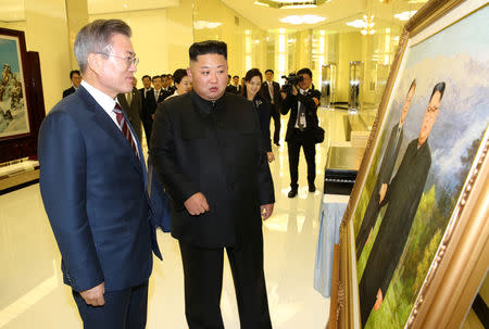 South Korean President Moon Jae-in and North Korean leader Kim Jong Un arrive for a banquet in Pyongyang, North Korea, September 18, 2018. Pyeongyang Press Corps/Pool via REUTERS