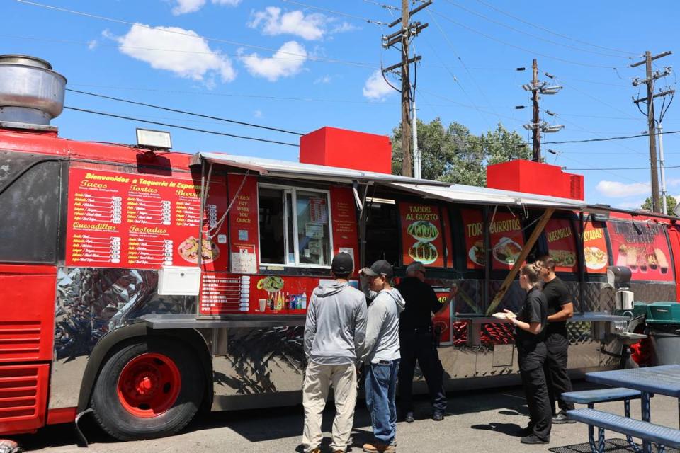 Customers order and pick up food from the Taqueria La Esperanza food truck on 4th Avenue in Pasco.