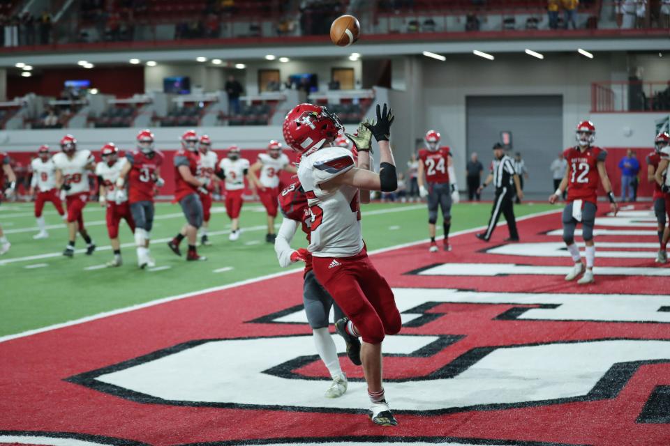 Dell Rapids St Mary RB #45 Nic Gaspar catches a touchdown pass over his shoulder in an overtime period of the 9A State Championship game against Potter County Thursday in the Dakota Dome.  Dell Rapids won 44-42 in double overtime.