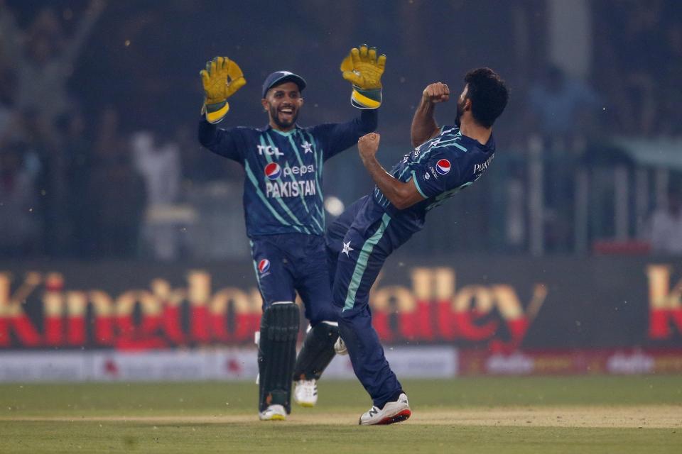 Pakistan's Aamer Jamal, right, and Mohammad Haris celebrate after winning the fifth twenty20 cricket match against England, in Lahore, Pakistan, Wednesday, Sept. 28, 2022. (AP Photo/K.M. Chaudary)