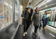 A woman wearing a face mask to protect against COVID-19 rushes on a subway platform in Paris, Thursday, June 30, 2022. Virus cases are rising fast in France and other European countries after COVID-19 restrictions were lifted in the spring. With tourists thronging Paris and other cities, the French government is recommending a return to mask-wearing in public transport and crowded areas but has stopped short of imposing new rules. (AP Photo/Michel Euler)