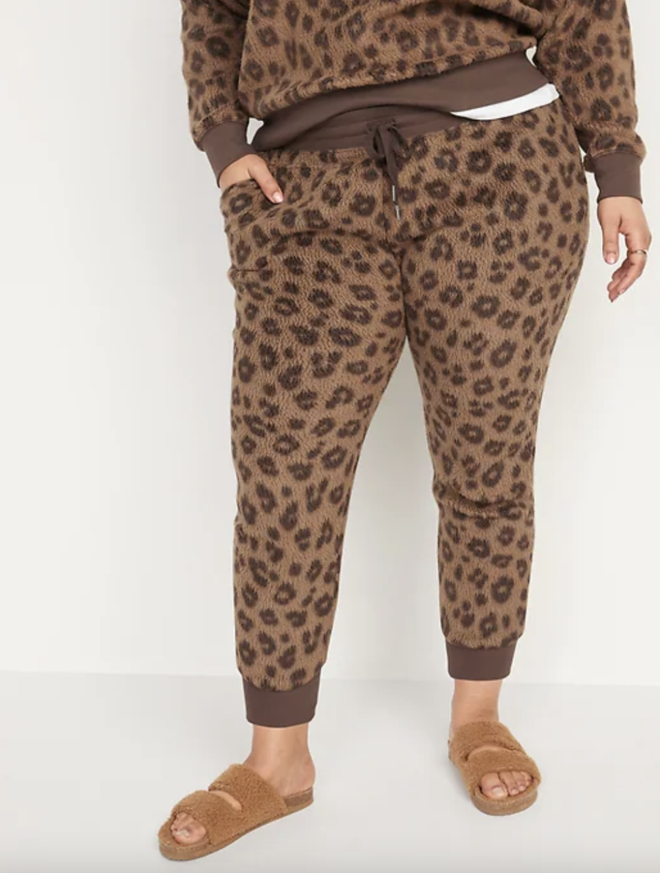 plus size model in leopard print Mid-Rise Vintage Sherpa Sweatpants (Photo via Old Navy)