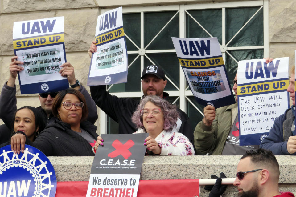 Atlantic City casino workers hold signs during a rally in Trenton N.J., Friday, April 5, 2024, after the United Auto Workers and casino workers filed a lawsuit challenging New Jersey's clean indoor air law that exempts casino workers from its protections. (AP Photo/Wayne Parry)