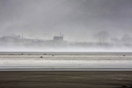 Wind blows salt from the bed of the dried-out Urmia lake, northwest of Iran October 4, 2013. REUTERS/United Nations Iran/Handout via Reuters