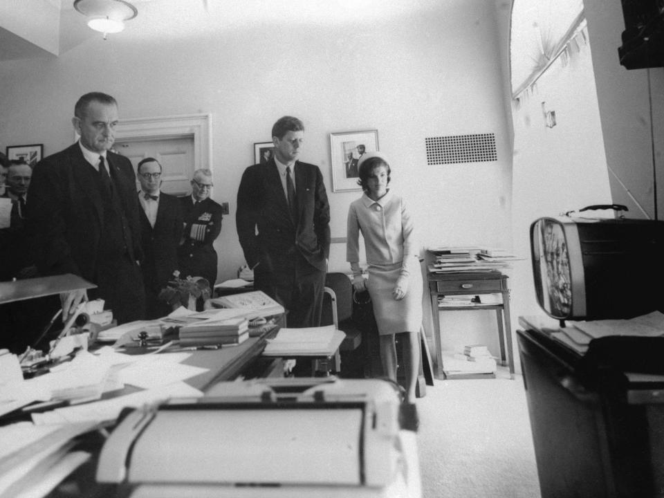 President John F. Kennedy and his wife and others watch coverage of a space flight in 1961.