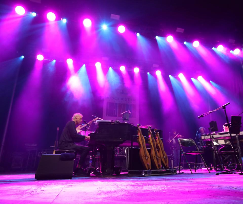 Under a flood of pink lights, Bruce Hornsby & The Noisemakers perform on the Wegmans Stage at Parcel 5 during the CGI Rochester International Jazz Festival in 2023.