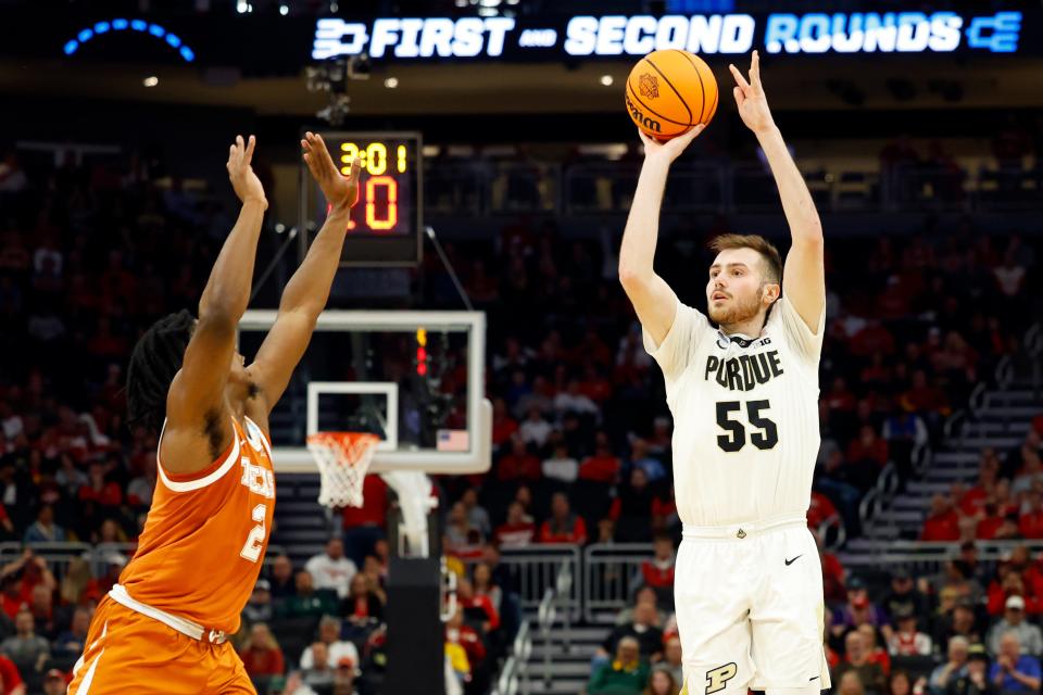 Mar 20, 2022; Milwaukee, WI, USA; Purdue Boilermakers guard Sasha Stefanovic (55) shoots against Texas Longhorns guard Marcus Carr (2) during the first half in the second round of the 2022 NCAA Tournament at Fiserv Forum.