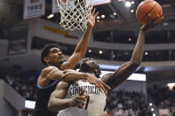 Villanova's Jermaine Samuels, left, fouls Connecticut's Adama Sanogo during the second half of an NCAA college basketball game Tuesday, Feb. 22, 2022, in Hartford, Conn. (AP Photo/Jessica Hill)