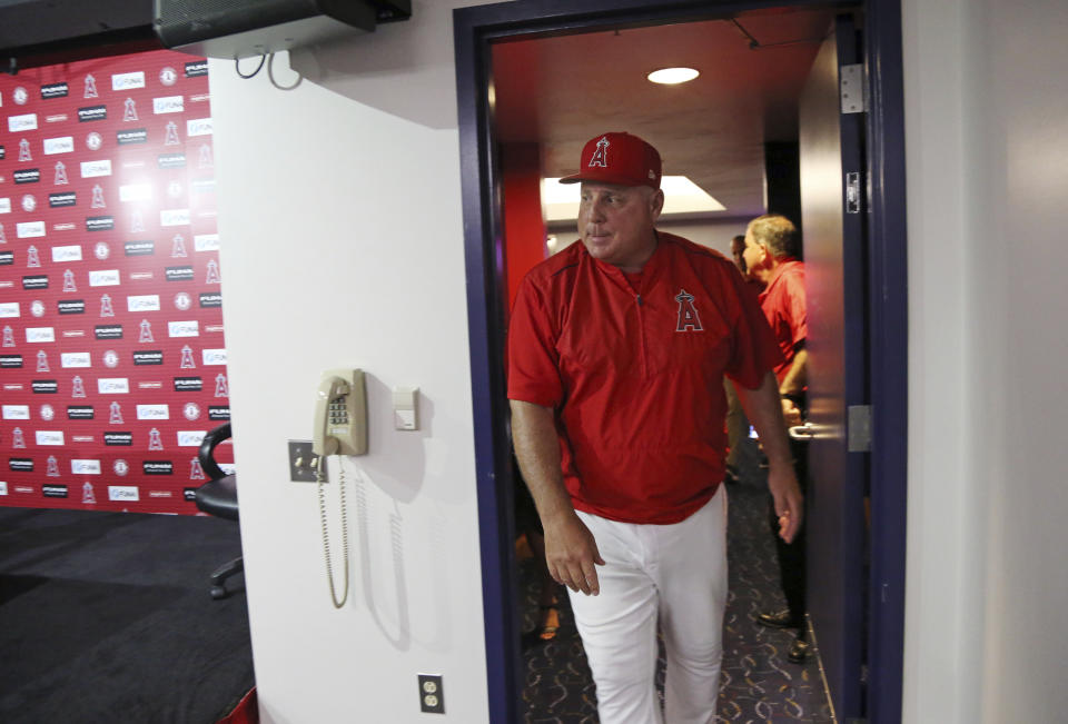 Los Angeles Angels manager Mike Scioscia enters the room to announce that he will not return as Angels manager after 19 seasons, ending the longest current tenure in Major League baseball, following his last game, a 5-4 win over the Oakland Athletics in Anaheim, Calif., Sunday, Sept. 30, 2018. (AP Photo/Reed Saxon)