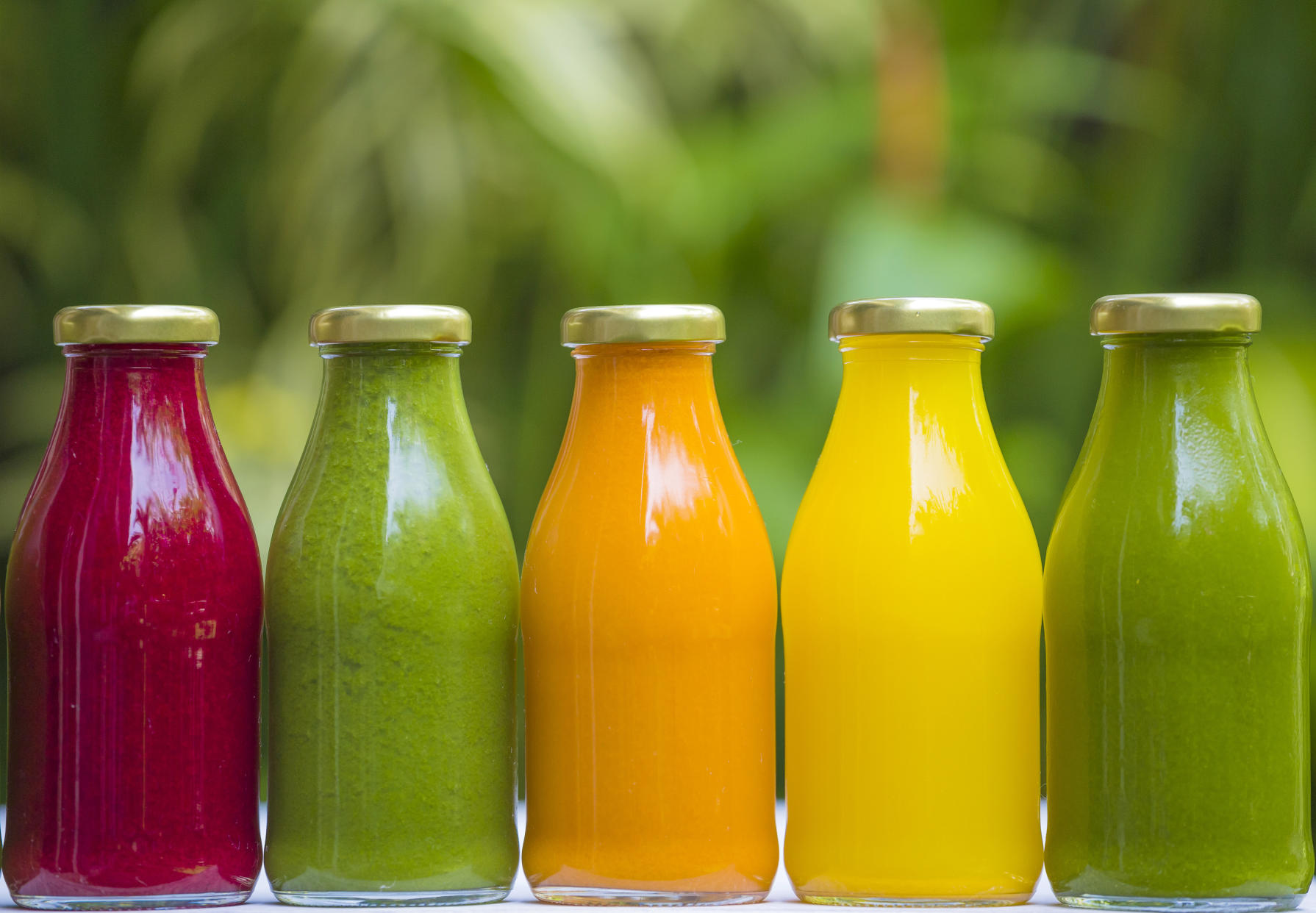Organic cold-pressed raw vegetable juices in glass bottles. Raw fruits can cause food poisoning. 