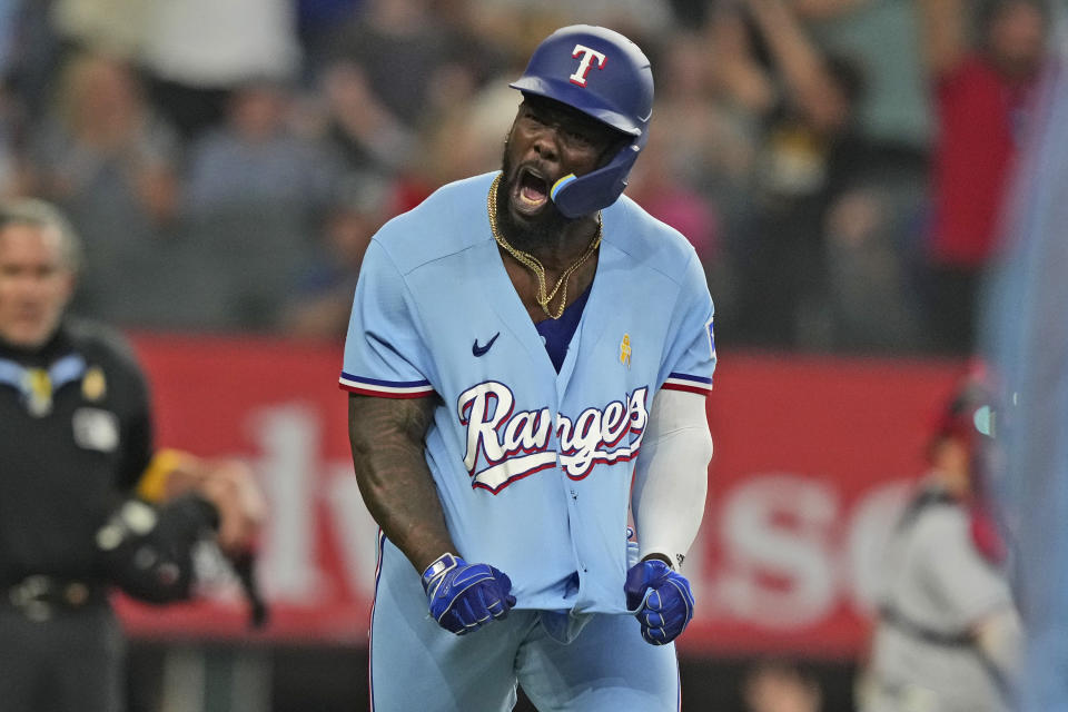 Texas Rangers' Adolis Garcia reacts to hitting a solo home run during the ninth inning of a baseball game against the Minnesota Twins in Arlington, Texas, Sunday, Sept. 3, 2023. (AP Photo/LM Otero)