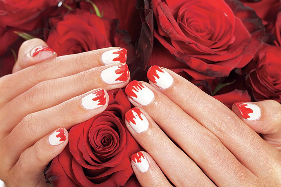 White and red vampire nails on rose background