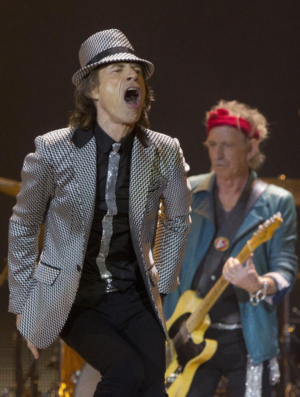 Mick Jagger, left and Keith Richards, of The Rolling Stones perform at the O2 arena in east London, Sunday, Nov. 25, 2012. The band are playing four gigs to celebrate their 50th anniversary, including two shows at London’s O2 and two more in New York. (Photo by Joel Ryan/Invision/AP)