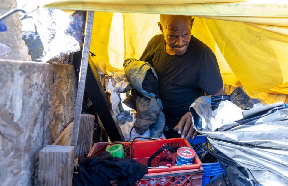 Dwight Thomas, 62, gathers up his belongings in a tent encampment on 86th Street and Broadway on Wednesday.