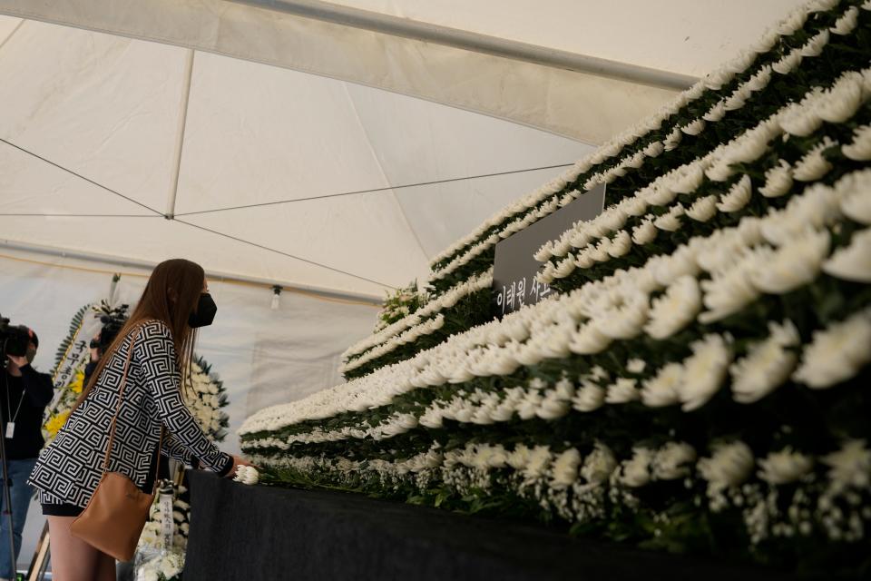 A mourner places flowers on Monday at a memorial for the victims of a deadly crowd surge incident in Seoul, South Korea.