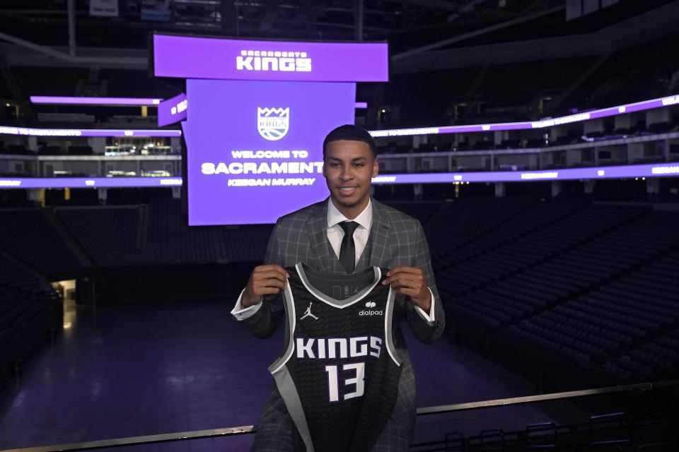 Keegan Murray, selected fourth overall by the Sacramento Kings in the NBA basketball draft, displays a team jersey during a news conference in Sacramento, Calif., Saturday, June 25, 2022. (AP Photo/Rich Pedroncelli)