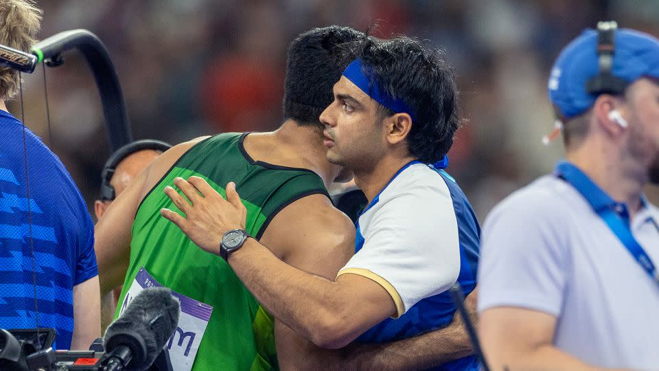 Arshad Nadeem of Pakistan and Neeraj Chopra of India embrace after their gold-silver medal finish at the 2024 Summer Olympic Games. - Tim Clayton/Corbis/Getty Images