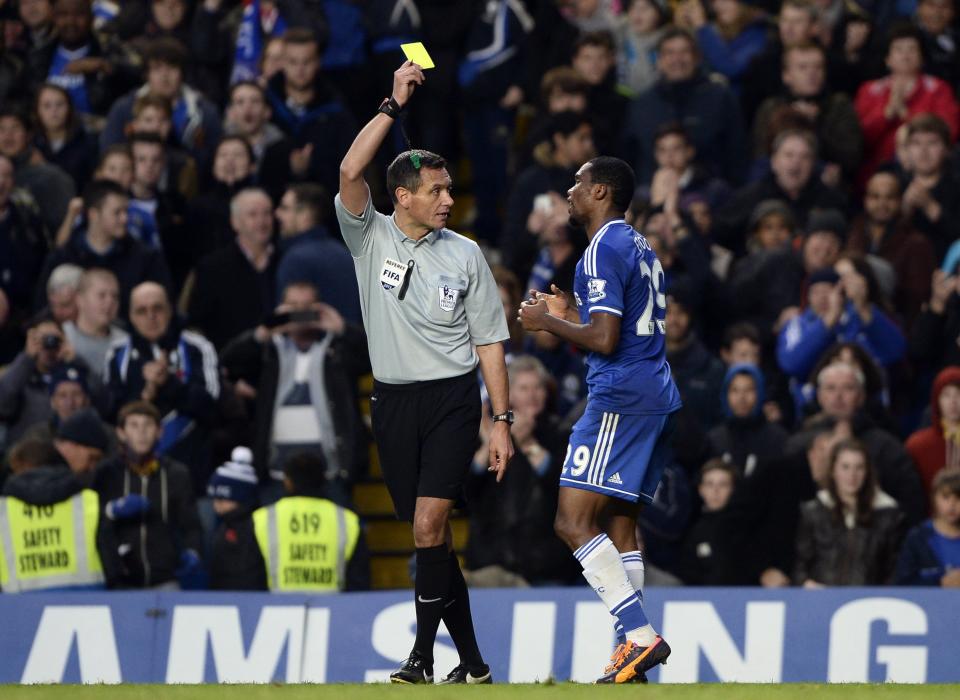 Chelsea's Samuel Eto'o (R) is shown a yellow card by referee Andre Marriner after celebrating his goal against West Bromwich Albion during their English Premier League soccer match at Stamford Bridge in London November 9, 2013.