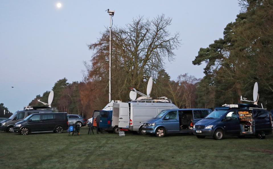 Media trucks gather in the early morning at the entrance of Sandringham on Jan. 13, 2020, before royal summit to discuss Prince Harry and Duchess Meghan's desire to reduce their roles in the royal family.