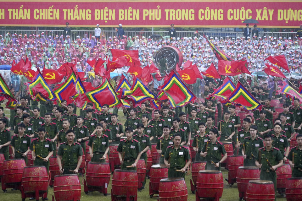 People participate in a parade commemorating the victory of Dien Bien Phu battle in Dien Bien Phu, Vietnam, Tuesday, May 7, 2024. Vietnam is celebrating the 70th anniversary of the battle of Dien Bien Phu, where the French army was defeated by Vietnamese troops, ending the French colonial rule in Vietnam. (AP Photo/Hau Dinh)