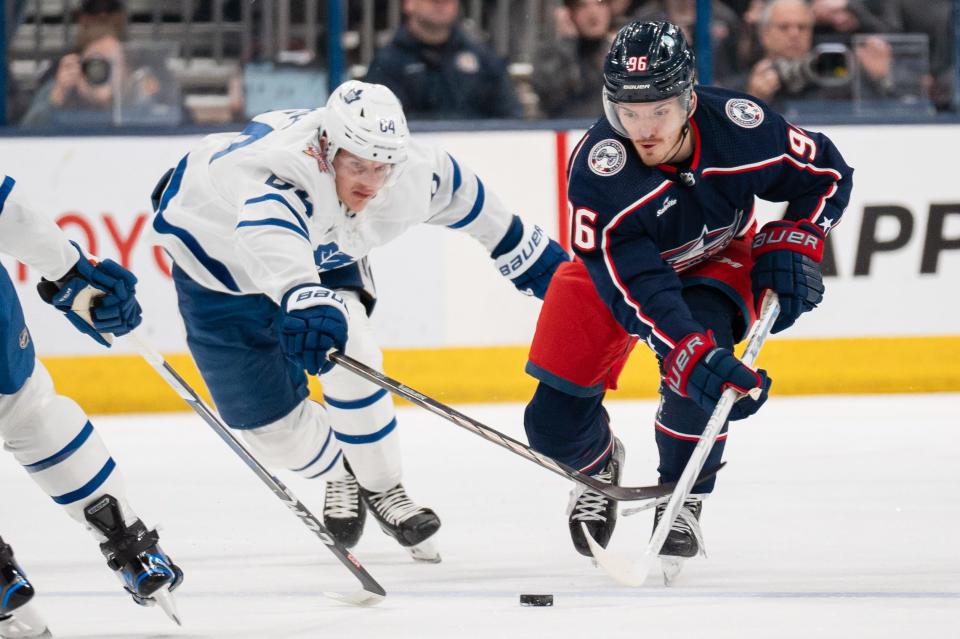 Dec 29, 2023; Columbus, Ohio, USA;
Columbus Blue Jackets center Jack Roslovic (96) reaches for the puck against Toronto Maple Leafs center David Kampf (64) during the first period of their game on Friday, Dec. 29, 2023 at Nationwide Arena.