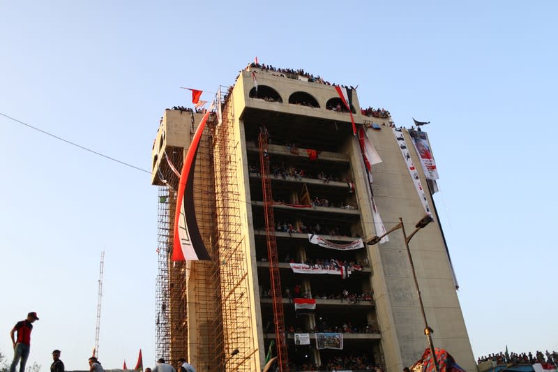 Iraqi demonstrators are seen inside the high-rise building, called by Iraqi the Turkish Restaurant Building, during anti-government protests in Baghdad