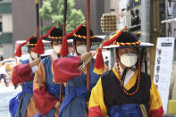 South Korean Imperial guards wearing face masks to help protect against the spread of the new coronavirus move near the Deoksu Palace in Seoul, South Korea, Friday, July 3, 2020. (AP Photo/Ahn Young-joon)