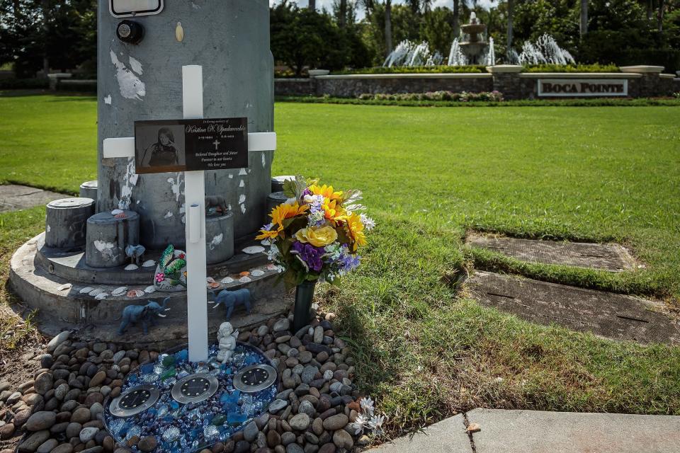 The roadside memorial to Kristina Spadavecchia, on the southeast corner of Powerline Road and Southwest 18th Street in suburban Boca Raton. Spadavecchia died in an auto accident in June 2021 at the intersection. The memorial contains rocks, glass decorations, a cross and several elephant figurines. It is located outside the Boca Pointe development. The memorial had been removed, but the family recently restored it.