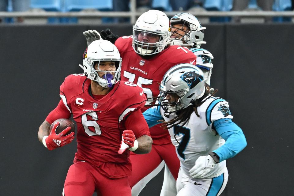 James Conner #6 of the Arizona Cardinals runs with the ball against Shaq Thompson #7 of the Carolina Panthers during the third quarter at Bank of America Stadium on October 2, 2022, in Charlotte, North Carolina.