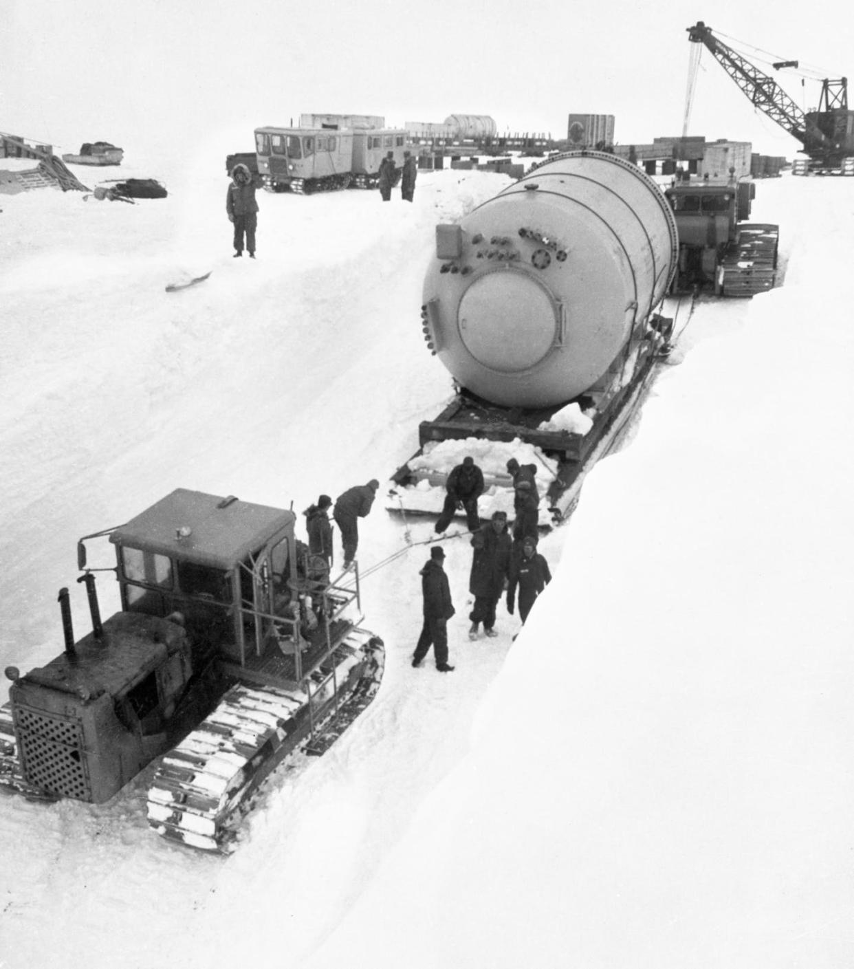 Part of a portable nuclear power plant arrives at Camp Century in 1960. <a href="https://www.gettyimages.com/detail/news-photo/the-u-s-army-engineers-who-are-installing-a-portable-news-photo/1180258522?adppopup=true" rel="nofollow noopener" target="_blank" data-ylk="slk:Bettmann Archive/Getty Images;elm:context_link;itc:0;sec:content-canvas" class="link ">Bettmann Archive/Getty Images</a>