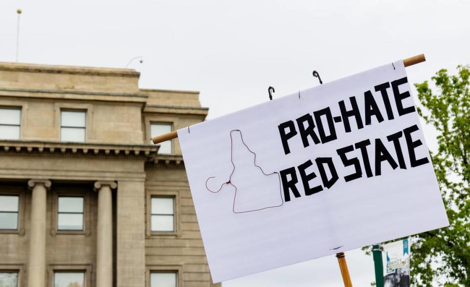 An attendee at Planned Parenthood’s Bans Off Our Bodies rally for abortion rights holds a sign reading “Pro-hate red state” with a hanger shaped as the outline of Idaho.