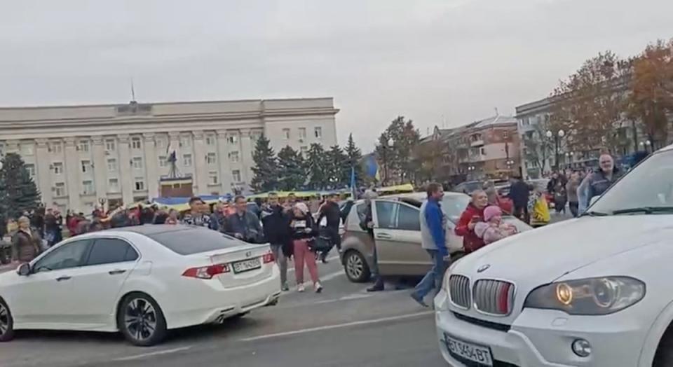 Crowds cheer and chant with Ukrainian soldiers in Kherson in this screen grab obtained from a video on Friday (via REUTERS)