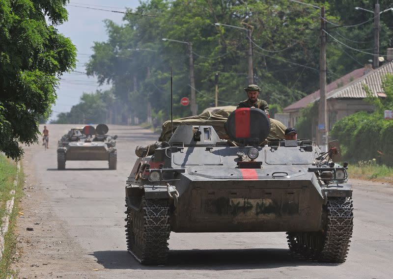 FILE PHOTO: Service members of pro-Russian troops ride an infantry fighting vehicle in Lysychansk
