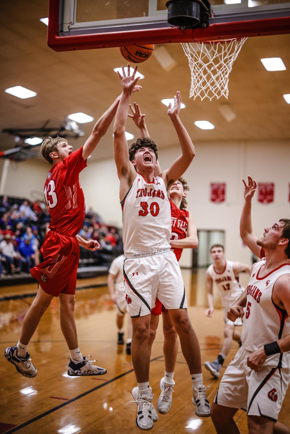 Caney Valley's Brayden Peckham rebounds and shoots while drawing a foul during Thursday night's game.