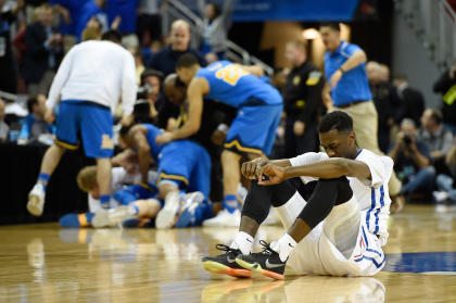 SMU's Ryan Manuel sits on the court after being upset by UCLA. (USAT)