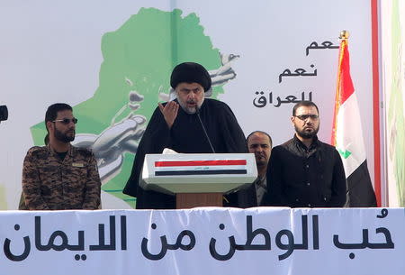 Prominent Iraqi Shi'ite cleric Moqtada al-Sadr (C) speaks during a protest against corruption at Tahrir Square in Baghdad February 26, 2016. REUTERS/Alaa Al-Marjani