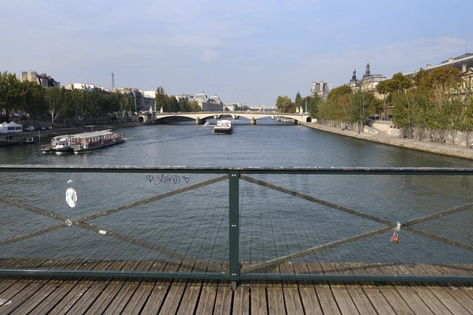 Two plastic panels are protecting the fence of the Pont des Arts over the River Seine in Paris September 23, 2014. (REUTERS/Jacky Naegelen)