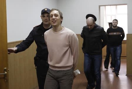 Bolshoi Theatre dancer Pavel Dmitrichenko (front L), together with his co-defendants, is escorted before a court session in Moscow October 31, 2013. REUTERS/Maxim Shemetov/Files