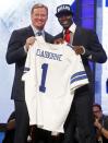 LSU cornerback Morris Claiborne, right, poses for photographs with NFL Commissioner Roger Goodell after being selected as the sixth pick overall by the Dallas Cowboys in the first round of the NFL football draft at Radio City Music Hall, Thursday, April 26, 2012, in New York. (AP Photo/Jason DeCrow)