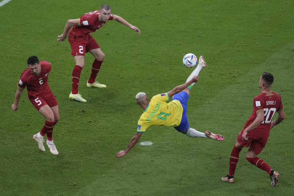 Brazil's Richarlison,second right, scores the second goal of his team against Serbia during the World Cup group G soccer match between Brazil and Serbia, at the the Lusail Stadium in Lusail, Qatar on Thursday, Nov. 24, 2022. (AP Photo/Darko Vojinovic)