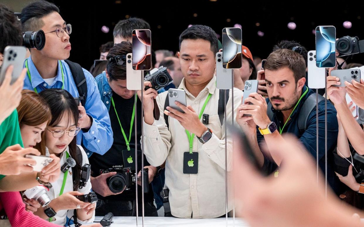 Attendees view new products during an event at Apple's HQ in Cupertino, California, yesterday