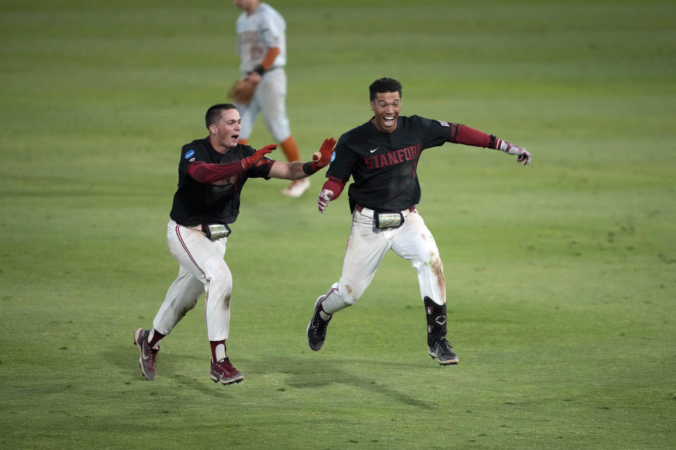 Stanford's Drew Bowser, right, celebrates with Malcolm Moore after hitting a single to score the winning run against Texas in the ninth inning of an NCAA college baseball tournament super regional game in Stanford, Calif., Monday, June 12, 2023. (AP Photo/Tony Avelar)