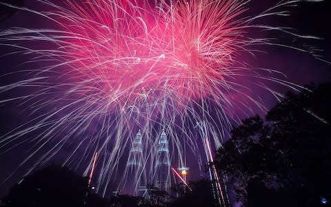 Fireworks explode above Petronas Twin Tower during New Year's Eve celebrations in Kuala Lumpur, Malaysia - Credit: Rex