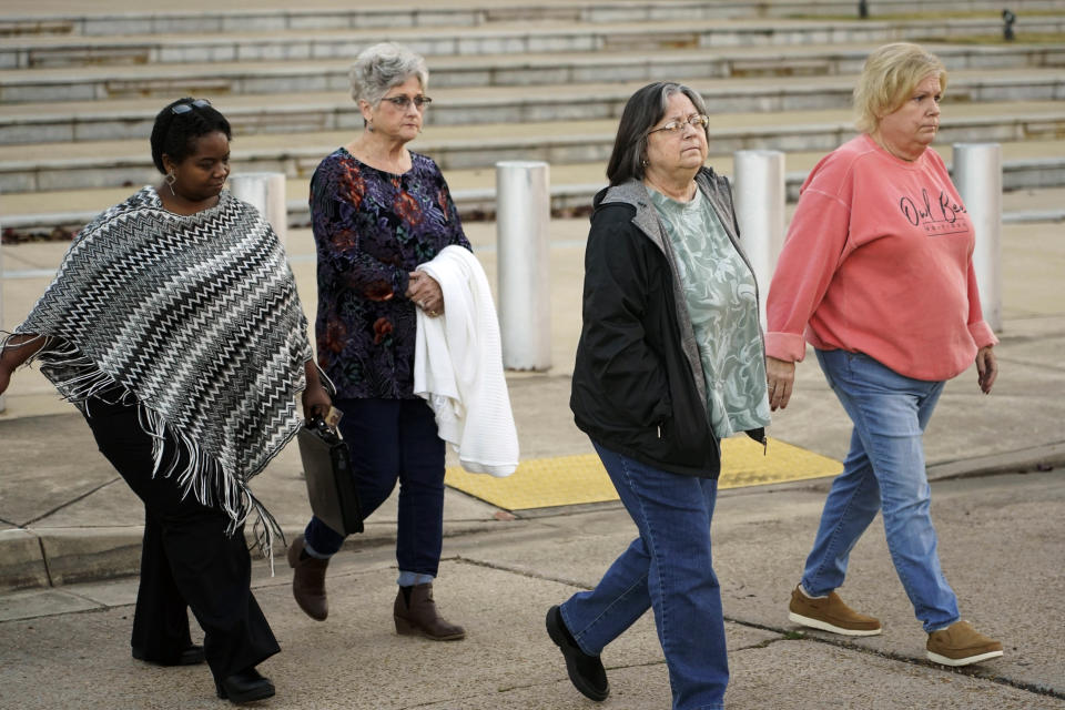 Wanda Farris, the mother of slain teenager Leesa Gray, second from right, is surrounded by supporters as she leaves the federal courthouse in Jackson, Miss., on Monday, Nov. 28, 2022, after they listened to several hours of arguments about Mississippi's three-drug protocol for executions. Thomas Edwin Loden Jr. pleaded guilty in 2001 to capital murder, rape and four counts of sexual battery in the 2000 death of Gray, a 16-year-old waitress from north Mississippi. Loden is a plaintiff in the lawsuit. The Mississippi Supreme Court has scheduled his execution for Dec. 14, 2022. (AP Photo/Rogelio V. Solis)